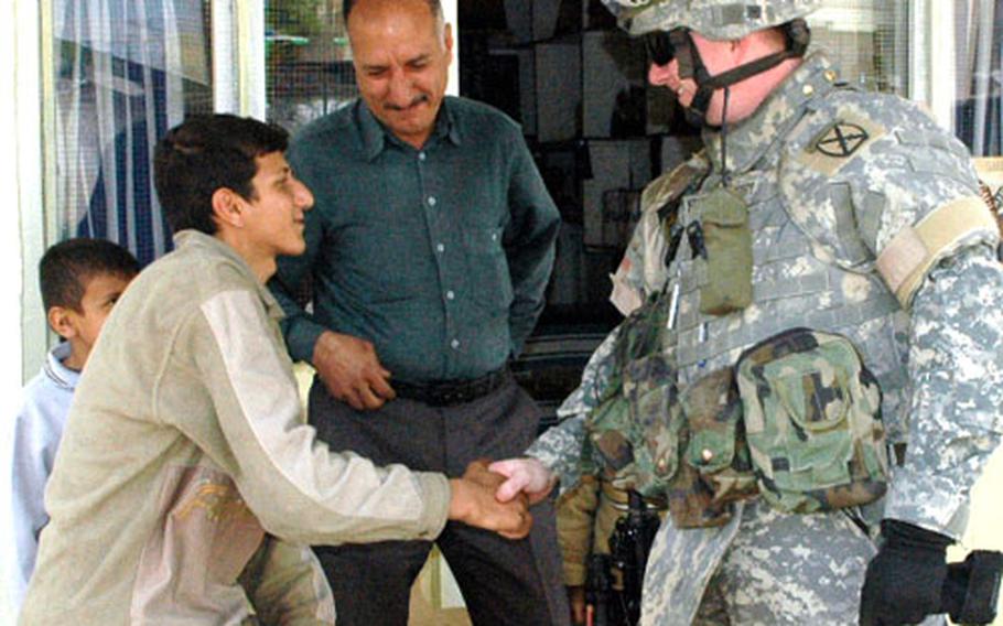 Capt. Mike Fortenberry greets residents after his unit returned here last month to assist Iraqi troops and quell sectarian violence.