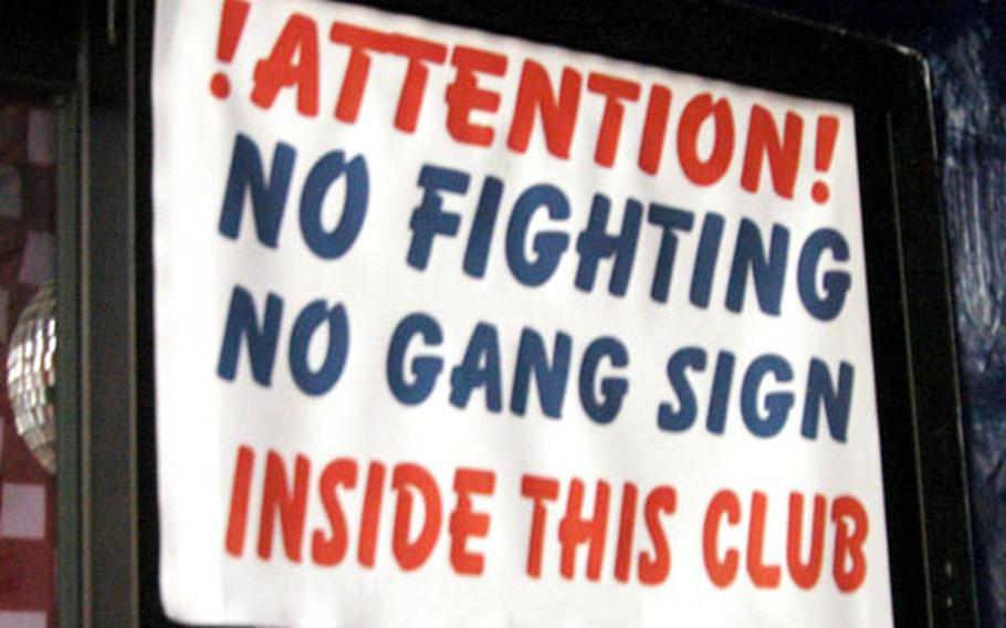 Geodana’s, a popular military dance bar in the Honch nightclub district near Yokosuka Naval Base, Japan, posts a sign referencing gang activity.