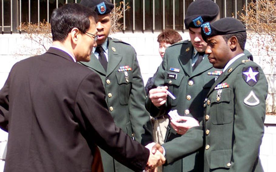From left, in uniforms, Pvt. Javon Joshua Reid, Spc. Nicholas John Durkin and Pfc. John D. McCall Jr. gather after their hearing on Friday at the Uijeongbu courthouse. The three, along with Pvt. Kidrem Cortez Porter and Spc. Ivey Nathaniel Westbrook, are charged with beating and robbing a Uijeongbu taxi driver.