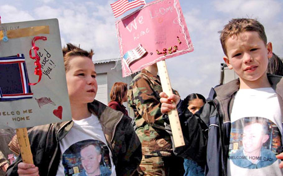 Richard and Seth Arnold donned custom “Welcome Home, Dad” t-shirts Friday to greet the USS Blue Ridge when it returned to Yokosuka Naval Base.
