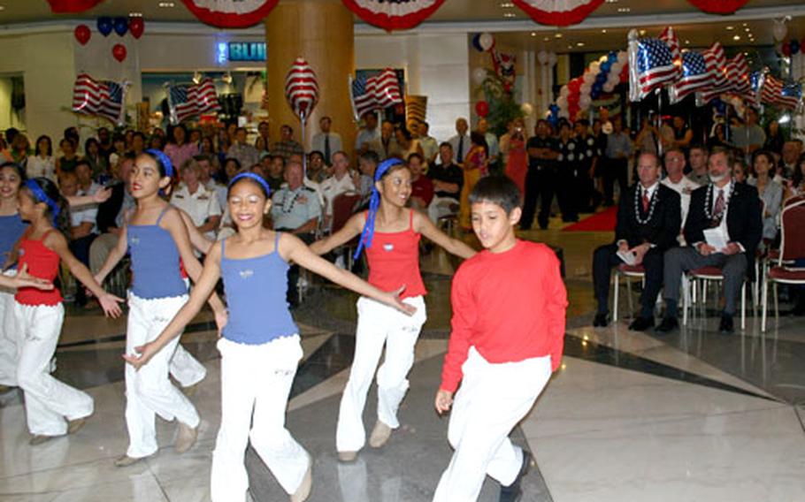 Members of local Guam dance troupe SKIP Entertainment perform during the opening ceremony of the Guam USO location in the Royal Orchid Hotel in Tumon, Guam.