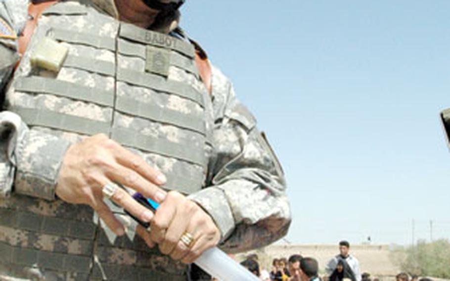 Master Sgt. Bobby Babot, 47, of Statesborough, Ga., inflates soccer balls donated by friends and family back home for distribution in the tiny village of Al Harza, in Southern Iraq, on Saturday.