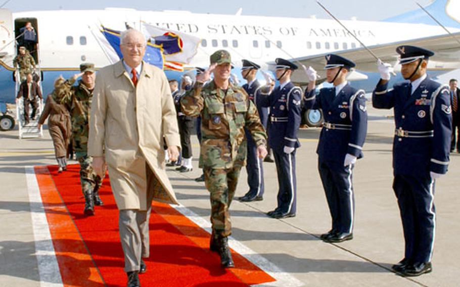Secretary of the Air Force Michael Wynne, in overcoat; Brig. Gen. Sam Angelella, 35th Fighter Wing commander, right; and Gen. Paul Hester, Pacific Air Forces commander, rear left, arrive at Misawa Air Base, Japan, on Saturday.