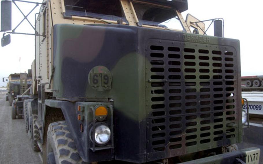 A HET, or heavy equipment transporter, prepares to continue a convoy to Baghdad International Airport. The massive truck and trailer system boasts 48 wheels and a trailer with rear-wheel steering. It is capable of hauling M1 tanks and some of the military’s heaviest equipment.