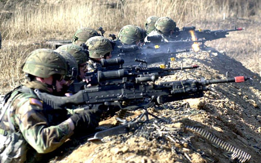 Soldiers from the 4th Stryker Brigade Combat Team, based in Fort Lewis, Wash., lay down blank suppressive fire Thursday in preparation for a live-fire exercise at Rodriguez Range.