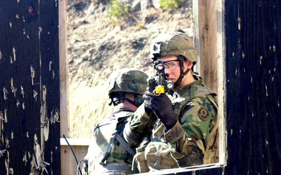 Soldiers from the 4th Stryker Brigade Combat Team, based in Ft. Lewis, Wash., secure a mock terrorist encampment in preparation for a later live-fire drill at Rodriguez Range on Thursday.