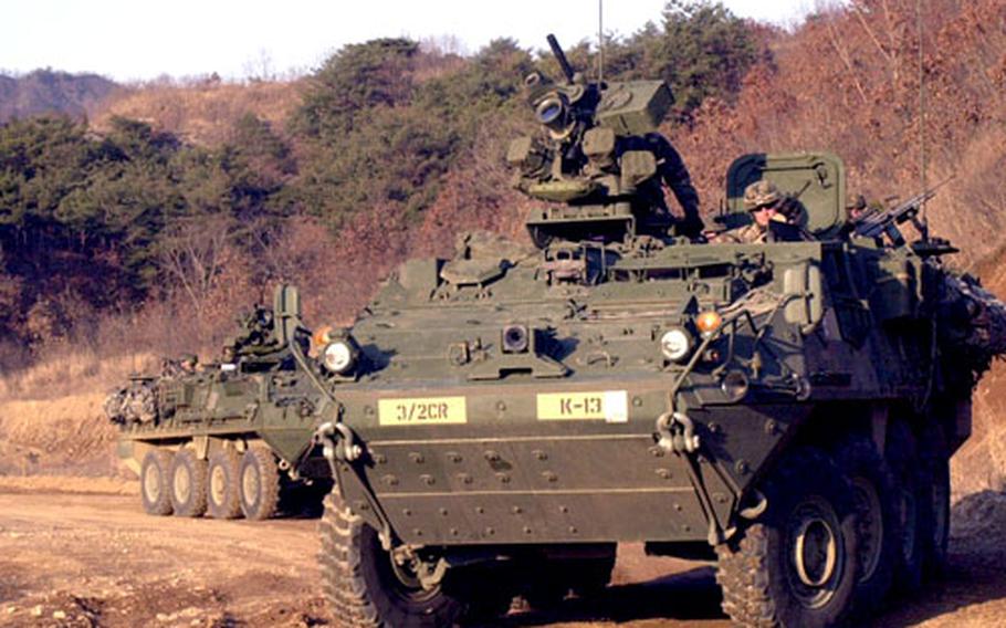 Soldiers from the 4th Stryker Brigade Combat Team roll toward their target during a live-fire exercise.