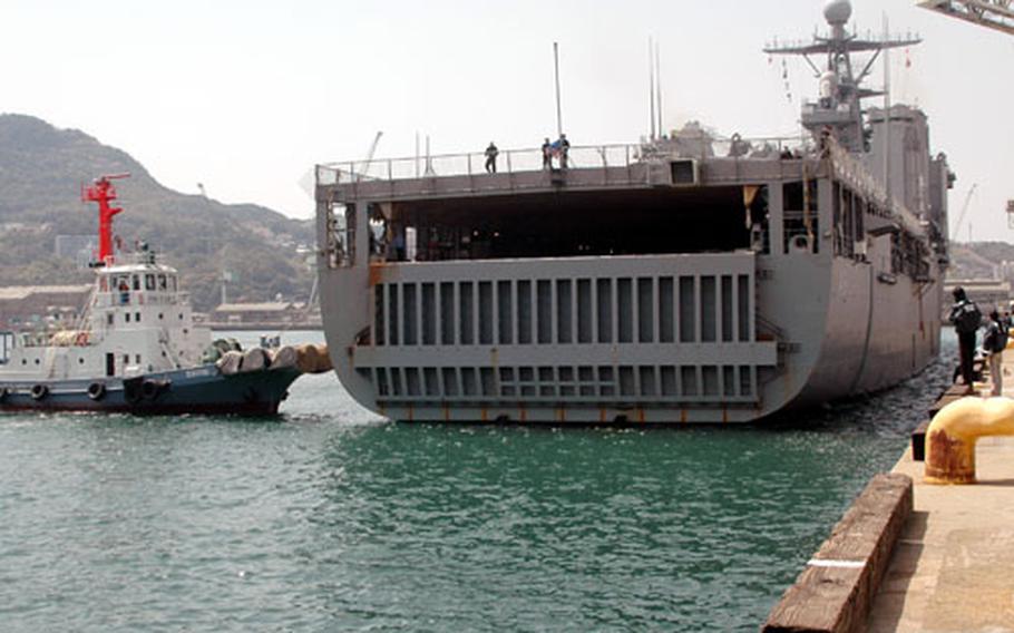 The USS Tortuga is gently eased by a harbor pilot’s tugboat into the India Basin pier at Sasebo Naval Base on Friday afternoon.