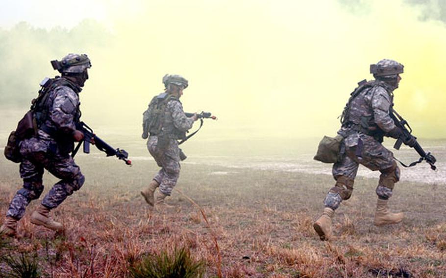 Lt. Cmdr. Gordon Jones, right, leads Naval Reservists and active-duty personnel in an urban warfare-training scenario during an Individual Augmentee Training Course. The Navy now has a cohesive program to train sailors to fight like soldiers before deploying to combat zones.