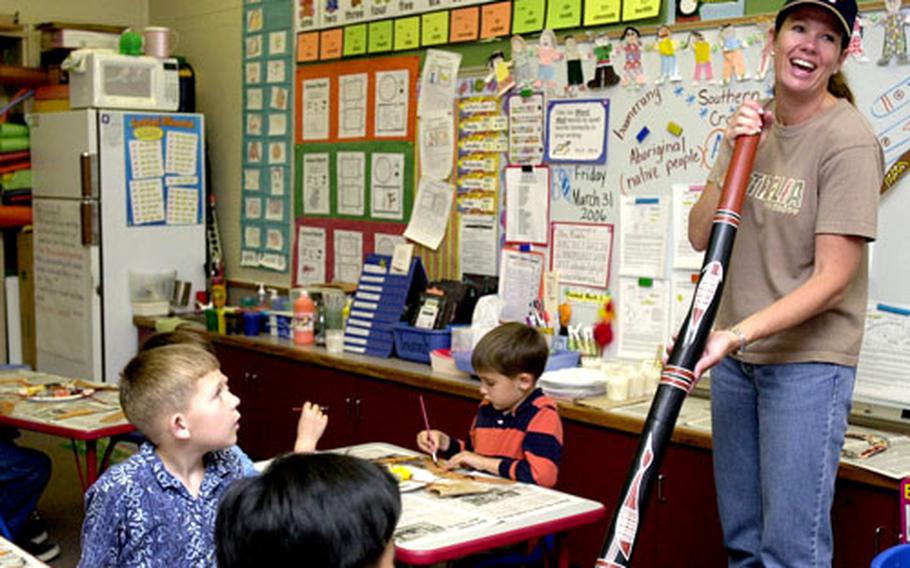 Kristina McMahon shows off a didgeridoo — an instrument of her native Australia — to students during Zukeran’s multicultural day.