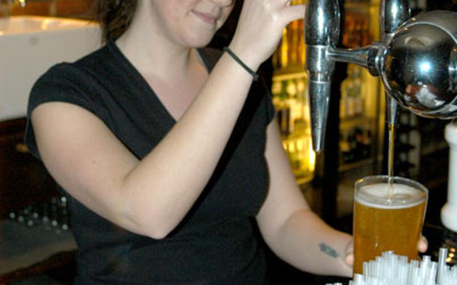 Victoria Miles pours a tall glass of Stella from behind the bar at Benson Blakes.