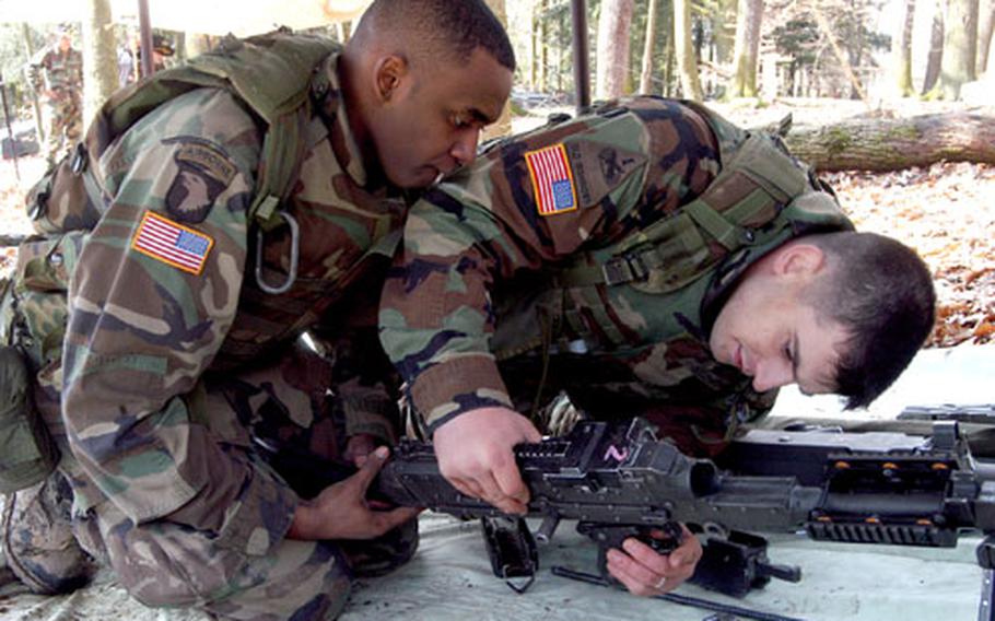 Sgt. Marcus Trammell, left, and Capt. Nick Schenck, both of 1st Squadron, 1st Cavalry Regiment, assemble an M-240 weapon as they try to earn their cavalry spurs.