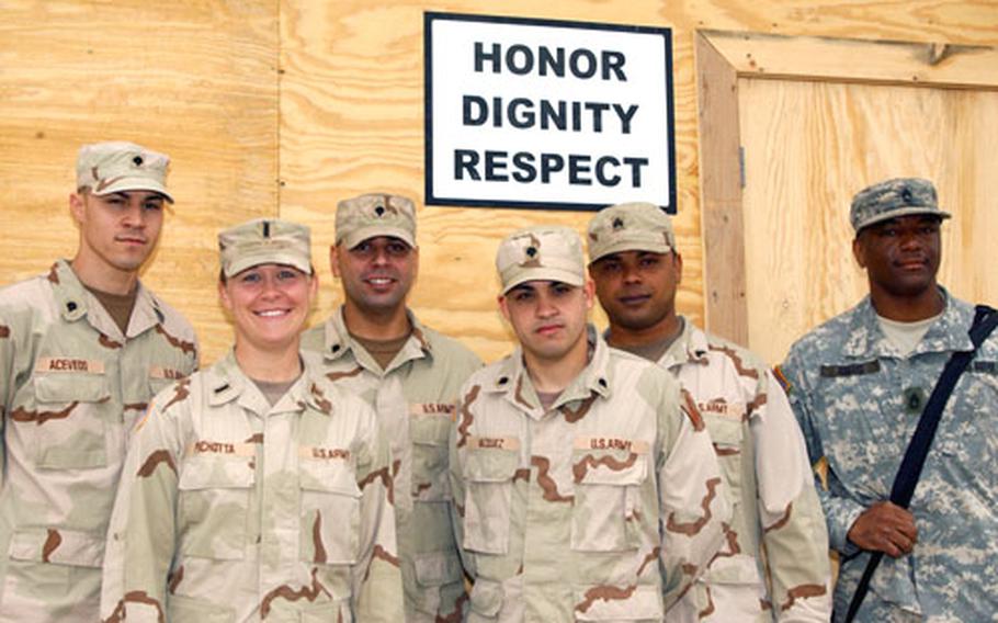 Members of the mortuary affairs team pose for a photograph at Camp Anaconda. From left: Spc. Felix Acevedo, 23, of the 311th Quartermaster Company, from Moca, Puerto Rico; Lt. Tracia Pichotta, 27, of the 400th Quartermaster Company, from Erlanger, Ky.; Spc. Jose Ortiz, 30, of the 311th Quatermaster Company, of Guyama, Puerto Rico; Spc. Jose Vazquez, 20, of the 311th Quartermaster Company, of Guyama, Puerto Rico; Sgt. Carlos Colon, 24, of the 311th Quatermaster Company, of Patillas, Puerto Rico; Sgt. 1st Class Freddie Adams, 26, of Logistical Task Force 548, from Forrest City, Ark.