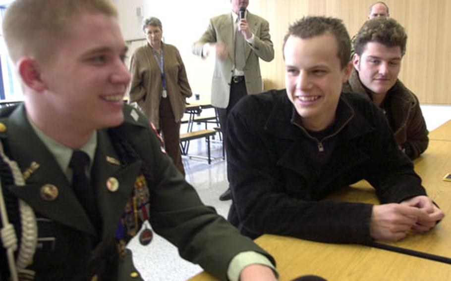 Hohenfels Junior Reserve Officer Training Corps battalion commander Patrick Smith, left, talks to Parsberg Gymnasium student Lukus Pirmay, 19, on Wednesday.