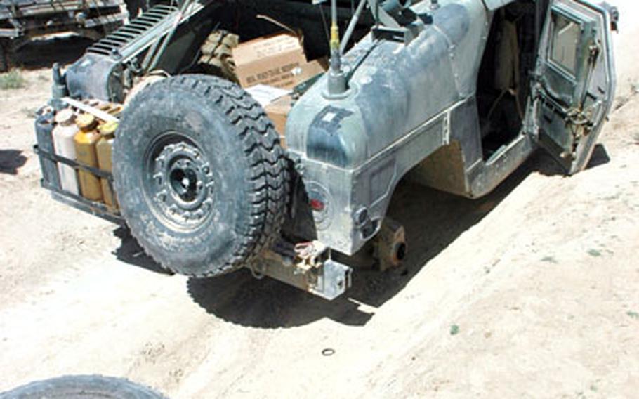 Soldiers examine a disabled Humvee in Zabul province during a mission Tuesday. Hours later, a rescue truck arrived to take them back to Forward Operating Base Laghman.