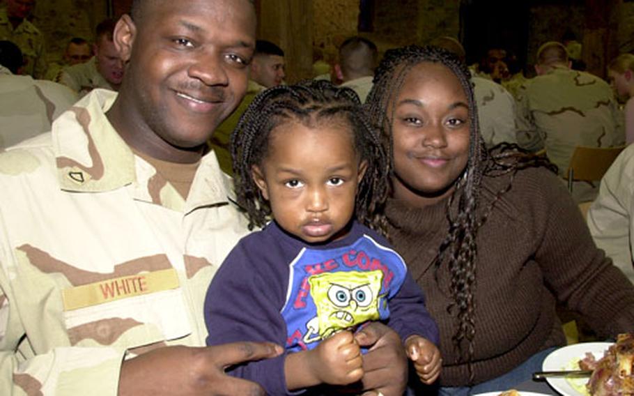 Company B, 94th Engineer Battalion soldier Pfc. George White, 21, of Augusta, Ga., enjoyed a feast Wednesday at Vilseck Castle with his wife Lakeisha, 22, and son Xzavius, 2. The party was a welcome back and a farewell for the 94th, which is returning to the U.S. in June. The 94th and 18th Combat Support battalions returned from Iraq in January.