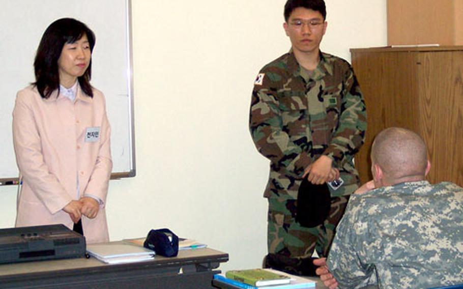 Yonsei University instructor Chun Jee-in, left, with aid from an interpreter, teaches 2nd Infantry Division soldiers about Korean language and culture at the beginning of a two-week course at the Camp Casey education center.