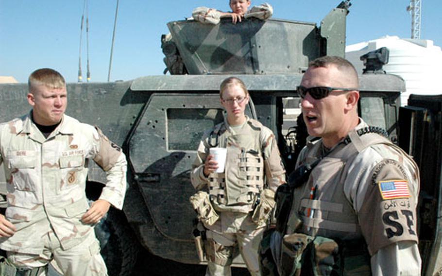 Air Force Tech. Sgt. Jeffrey Fort, right, briefs Giere, left; Airman First Class Kristen Fluegel, center; and turret gunner Airman Britney Simpson before going on patrol outside Ali Base.