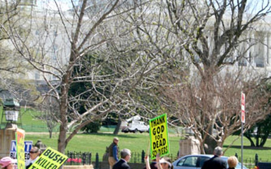 Tourists walk past protesters from the Kansas-based Westboro Baptist Church during a demonstration outside the U.S. Capitol on Thursday. Church members, who have been picketing military funerals across the country, were in Washington to protest a new federal law which would limit those types of demonstrations.