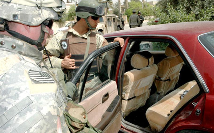 Capt. Mike Fortenberry examines red stains on the back seat before deciding not to detain an Iraqi driver.