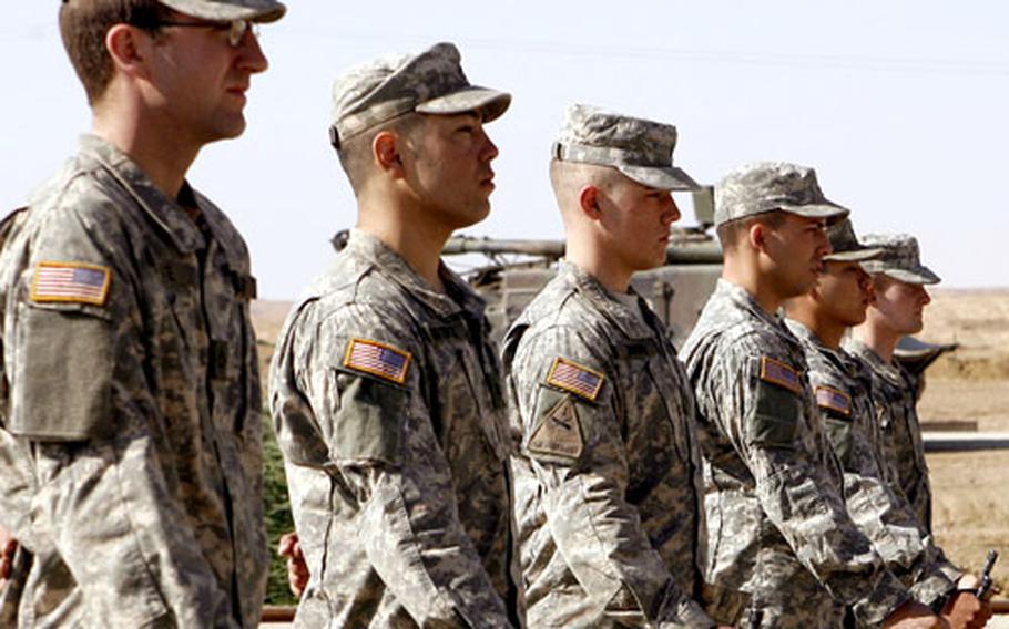 A seven-man rifle detail stands at “parade rest” prior to rendering a 21-gun salute.