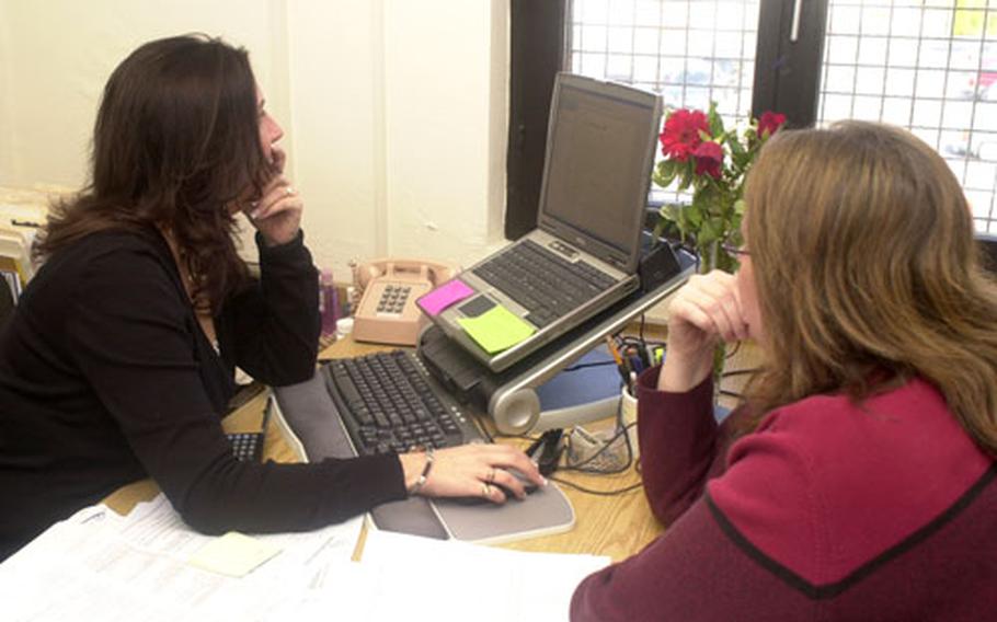 Carla Wiggins, tax coordinator for Würzburg and the 1st Infantry Division, scans her computer screen as she helps a family member complete her taxes. Nearly 90 percent of the people who go to the 1st ID tax assistance centers are entitled to a refund.
