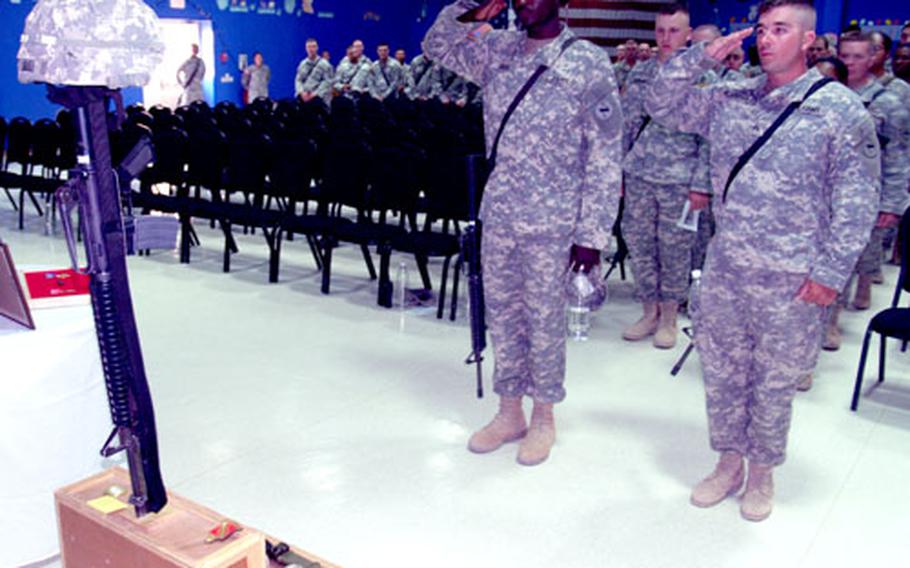 Soldiers pay their respects at a memorial service for Pfc. Joseph Love, killed by a roadside bomb Sunday.