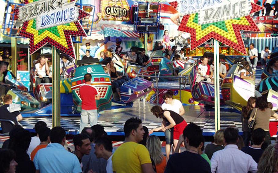 Festgoers gather around a popular ride during last year’s Frühlingsfest.