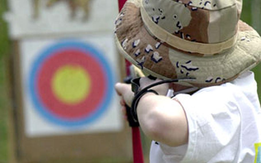 A young archer takes aim at his targets during the Boy Scouts’ spring break camp.