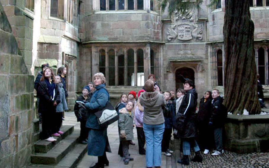 Members of a school group touring Skipton Castle look around the Conduit Court, an inner courtyard that held the water supply for the fortress.