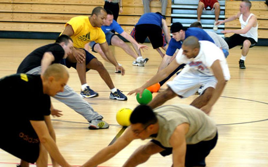 Dodgeball players rush to center court at the start of a game.