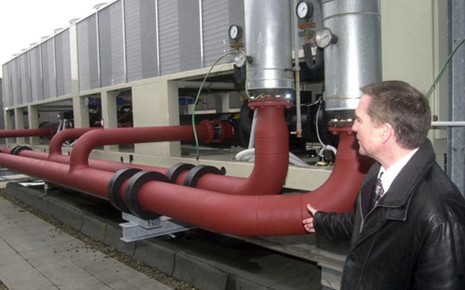 Michael Arseneau, chief of facility management at Landstuhl, explains the operation of a new chiller unit on the roof at Landstuhl Regional Medical Center. The chiller is part of a project to bring air-conditioning to the entire hospital for the first time since it opened in the 1950s.