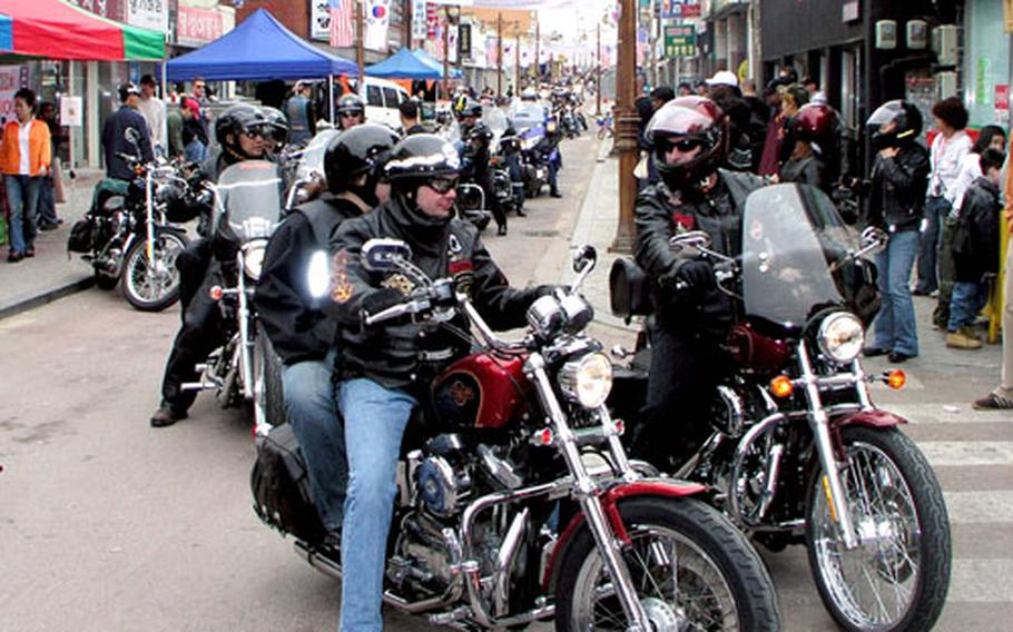 Near Camp Humphreys in South Korea on Saturday, a long line of bikers moves down Rodeo Drive in the Anjung-ri section of Pyeongtaek City during second annual bike fest.