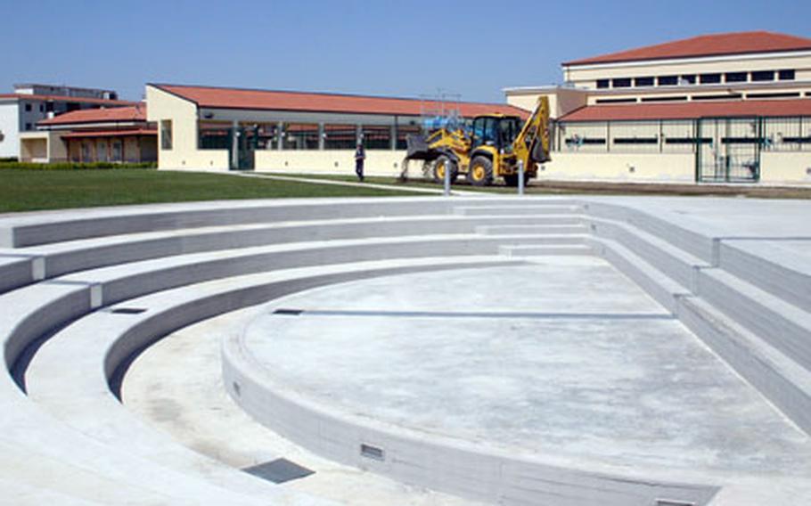 A bulldozer sprinkles dirt Friday to touch up the grassy area surrounding the soon-to-open amphitheater at the U.S. Navy support site base at Gricignano, near Naples, Italy.