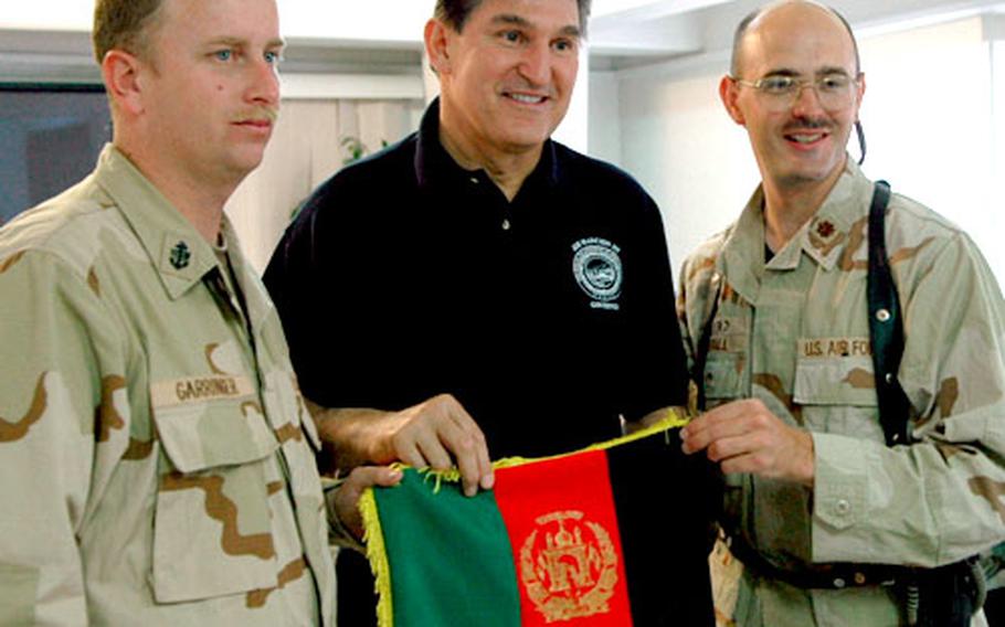 West Virginia Gov. Joe Manchin III, center, poses wearing a prayer cap presented to him by fellow West Virginians Navy Chief Officer Bryan Garringer, left, and Air Force Maj. JD Duvall.