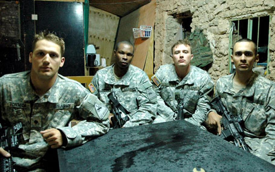 From left: Spc. Jason Fonseca, 25, of New York, N.Y.; Staff Sgt. Jeff Anderson, 24, of Montgomery, Ala.; Sgt. Mikeal Auton, 23, of Lenoir, N.C.; and Pfc. Victor Flores, 21, of Phoenix, Ariz., sit at Combat Outpost Burma shortly after tangling with an insurgent in northeast Tal Afar on Monday.