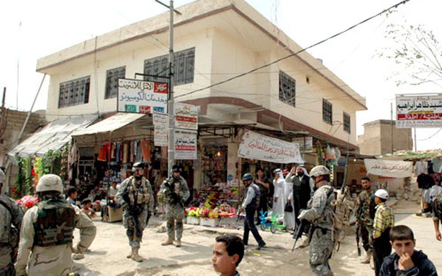 Soldiers from the 1st Battalion of the 37th Armor Regiment, 1st Brigade, 1st Armored Division patrol the streets of Sinjar in northwestern Iraq recently.