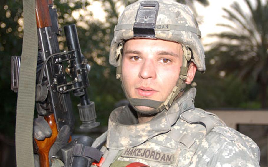 Sgt. Nicholas Hake-Jordan, 23, of 1st Battalion, 68th Armor, from Springfield, Ore., holds a new sniper rifle seized during a patrol that also yielded one dead insurgent thanks to a sly interpreter.