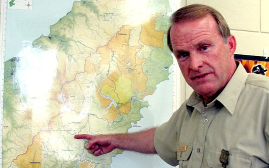 Larry Soenen, a soil scientist with the U.S. Forest Service, describes areas of Marine Corps bases on Okinawa where the red soil runoff problem is being combated successfully.