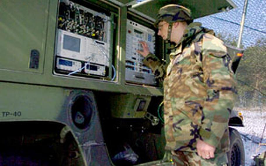 Sgt. Jason Schmidt, Company C, 44th Signal Battalion, monitors receive levels on a Phoenix tactical satellite terminal in Darmstadt, Germany, during an exercise last month. Signal units throughout Europe are changing as part of the Army’s transformation takes place.
