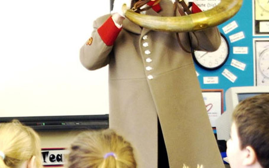 Eugene “Geno” Boarman blows a note on a 120-year-old ox horn for students at Moorside Junior School in Ripon.