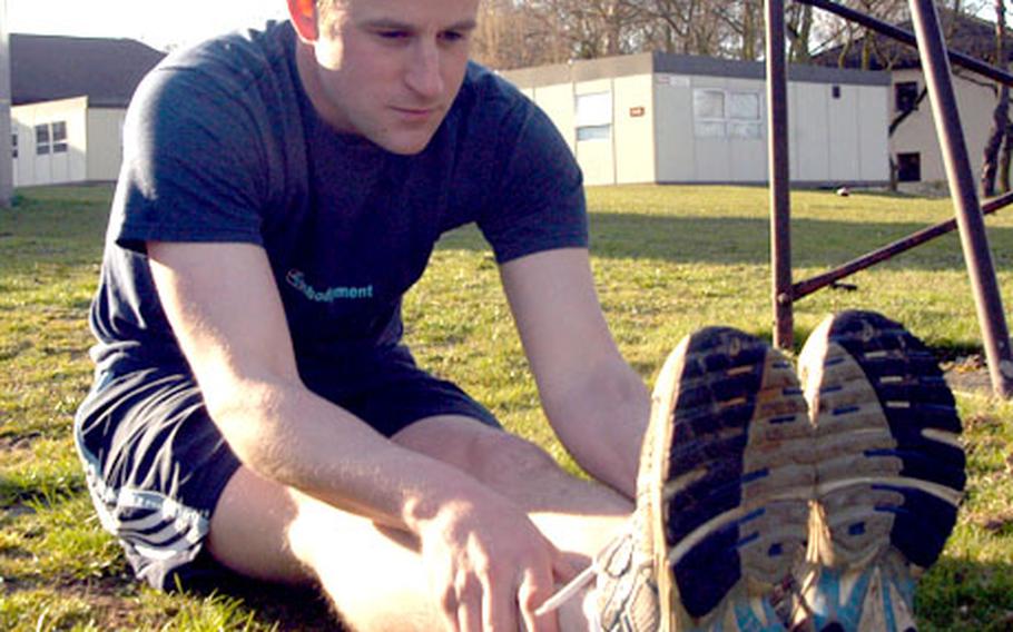Senior Airman Jeremiah Moore, 22, stretches before a run around RAF Lakenheath. Moore said he runs about 20 to 30 miles per week.