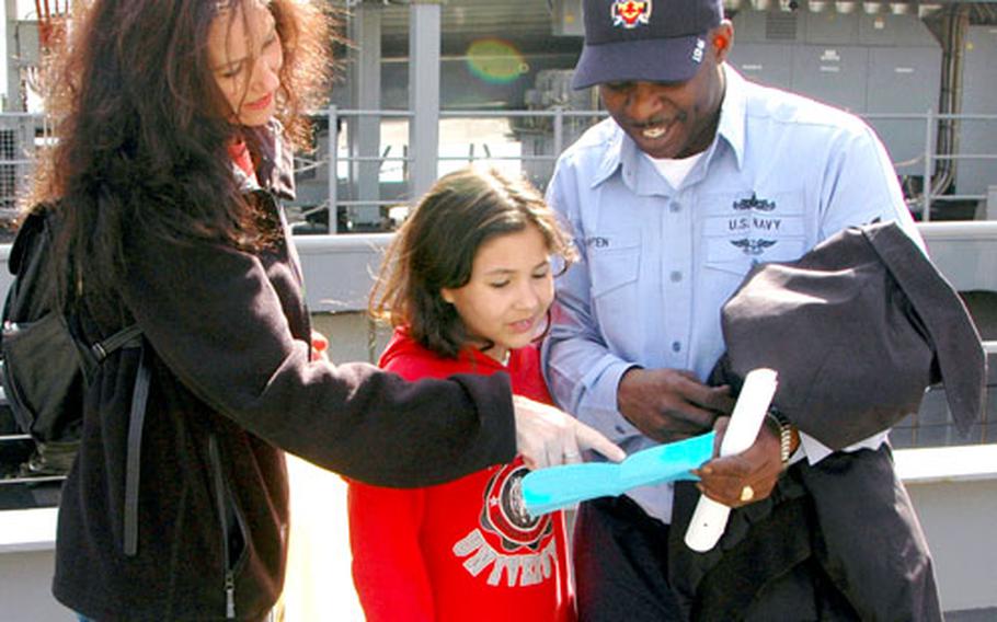 Petty Officer 1st Class Ernest Pippen and 4th-grader Sarah Maloy, 10, pen pals during the current school year, enjoyed a visit aboard the USS Tortuga on Tuesday. Karissa Maloy, Sarah’s mother and field trip chaperone, listened in.