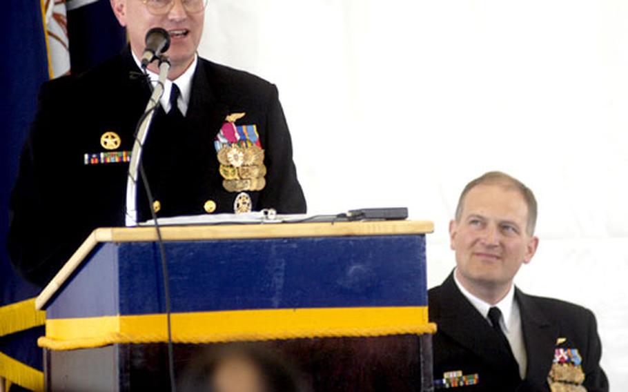 USS Mount Whitney's outgoing commander, Capt. C. Ladd Wheeler, speaks to guests as incoming commander Capt. Joseph W. Kuzmick listens. Wheeler commanded the Mount Whitney for about 14 months, having taken over as the ship was undergoing numerous major changes in personnel, home port and mission.