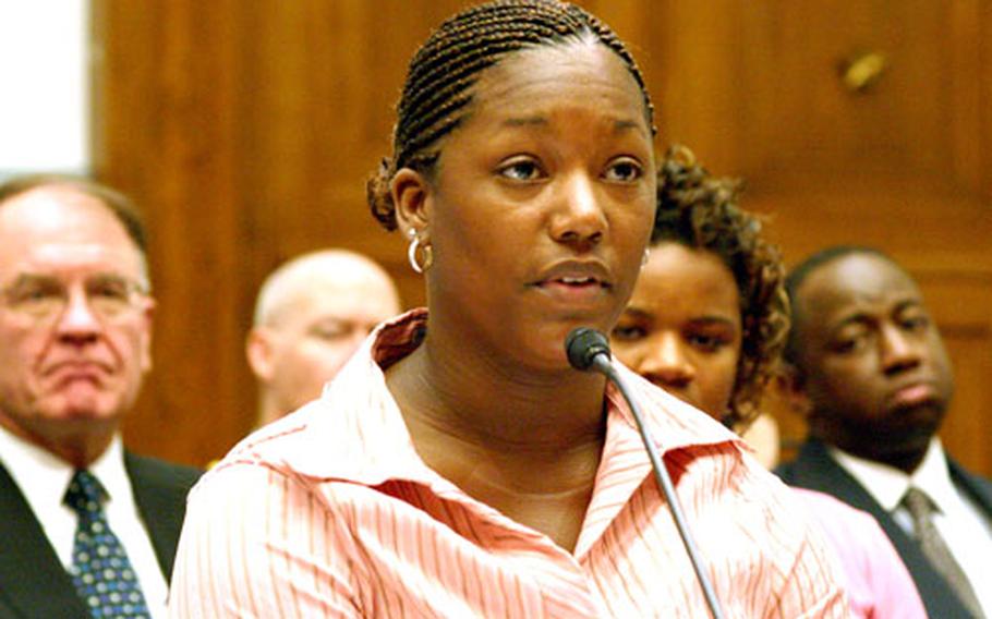 Spec. Brandy Taylor, a former Army Reservist from the 296th Transportation Co., testifies at Thursday's hearing of the House Committee on Government reform in Washington.