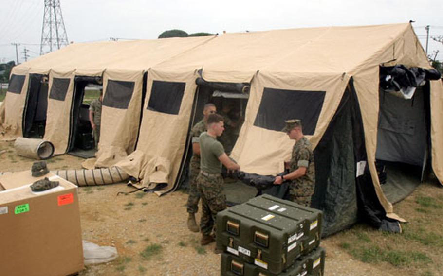 Marines with the 31st Marine Expeditionary Unit disassemble the new Unit Operation Center recently on Camp Hansen during a weeklong training course.