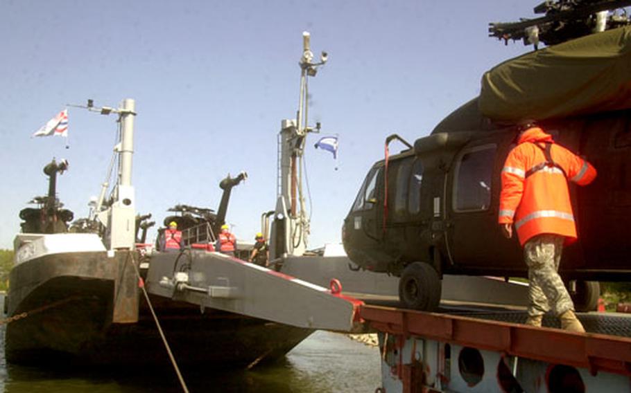 Black Hawk helicopters are loaded onto a barge in Mannheim, Germany, Friday morning as the last helicopters from the 1st Infantry Division headed to the States begin their journey to Fort Riley, Kan.