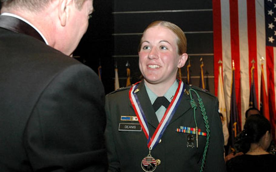 Pfc. Randi Deanis, 20, of Meadville, Pa., accepts her Six-Star medal Thursday night. The USO fundraiser honors junior enlisted soldiers from the United States, South Korea and other countries, treating them like a six-star officer for a night.