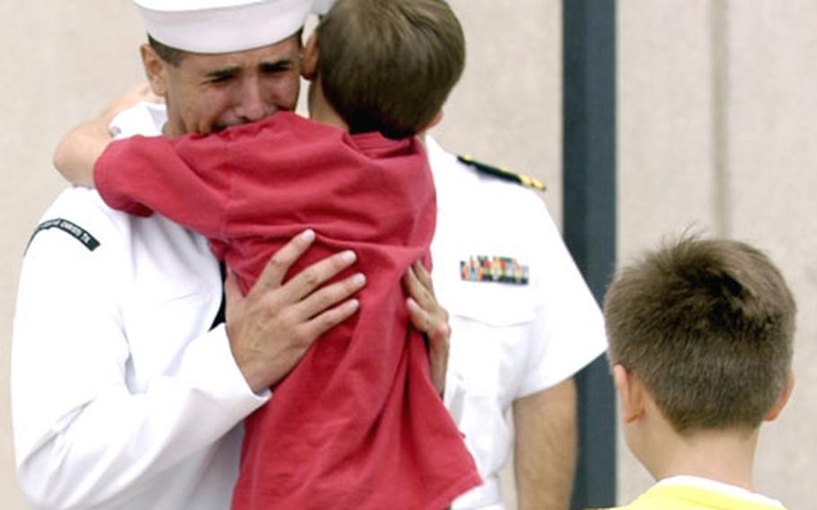 Hospital Corpsman 2nd Class Juan M. Rubio gets a hug from one of his children after he was awarded the Silver Star.