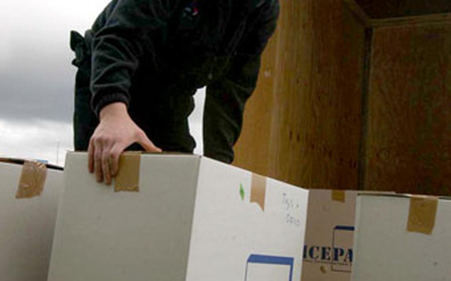 Mover Ingi Thor Einarsson loads up boxes of household goods from an on-base home at Naval Air Station Keflavik, Iceland, where families are leaving the base in droves ahead of an Oct. 1 closing date.